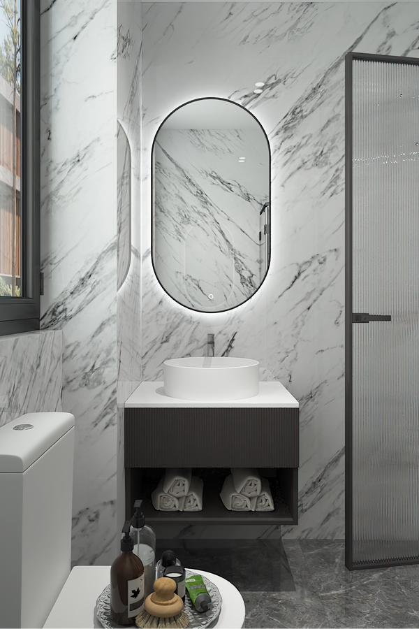 Modern bathroom with marble walls, a vanity, and toiletries.