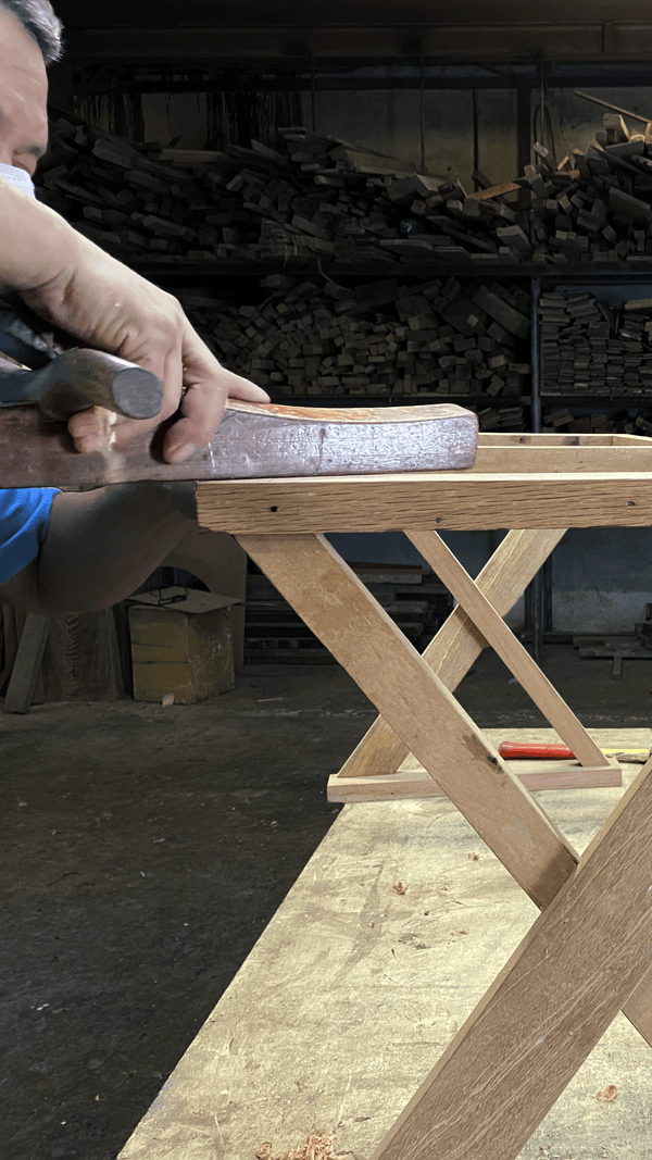 Carpenter in Singapore manufacturing a Solid Wood Desk using Timber Locally Sourced