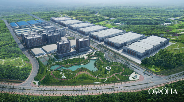 Aerial view of a large industrial complex surrounded by greenery with 'Oppolia branding.
