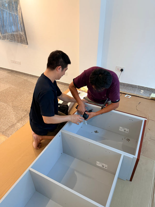 Landed house in Singapore where carpenters a drilling a decorative panel with moulding on a kitchen cabinet 