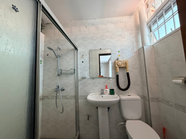 Bathroom with shower, sink, and toilet