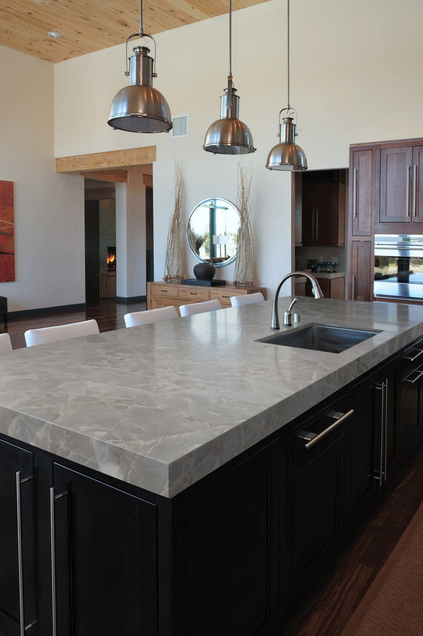kitchen in singapore landed house with black kitchen island, grey countertop, wood cabinet